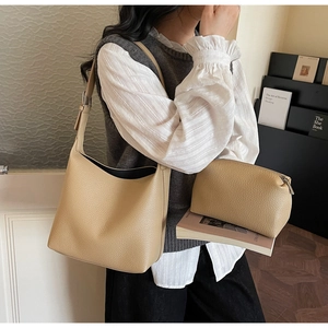 Detail of beige lychee grain leather tote bag set including a matching zipper pouch