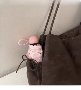 Compact pink folding umbrella fits perfectly in a tote bag side pocket for easy carry