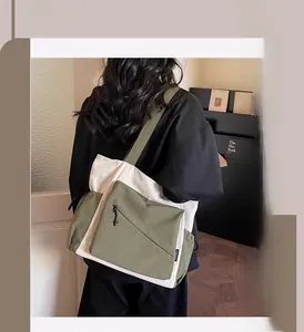 Detail of spacious tote bag featuring olive green and cream canvas patchwork design
