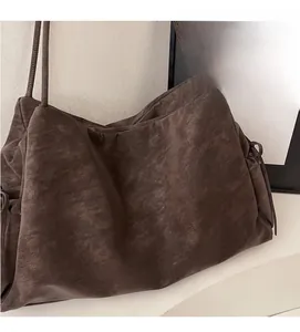 Detailed close-up of retro brown tote bag featuring textured leather and embossed logo