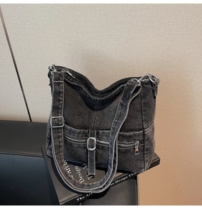 Detail of dark grey washed denim tote with contrast stitching and adjustable strap