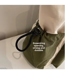 Macro detail of the drawstring opening on a canvas tote bag with metal grommets