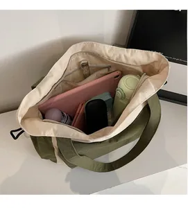 Interior view showing the large capacity and pockets of the green tote bag