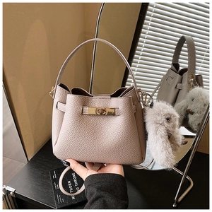 Detail of light purple bucket bag with lychee grain leather and golden twist lock