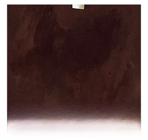 Detailed macro view showing the soft matte texture of dark brown frosted suede leather