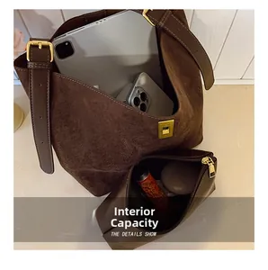 Interior capacity of the brown suede tote bag showing tablet and makeup storage