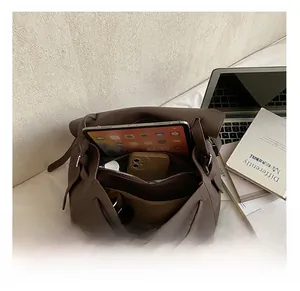 Detail view of large capacity interior with zipper compartment for tablet and phone