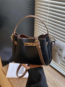 Fashionable black and brown leather bucket bag with metal lock and rabbit charm