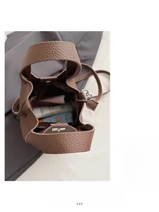 Internal view of brown textured leather bucket bag showing large capacity and storage space