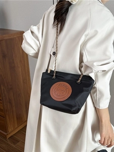 Black nylon crossbody bucket bag with chain strap and cute dog leather patch detail
