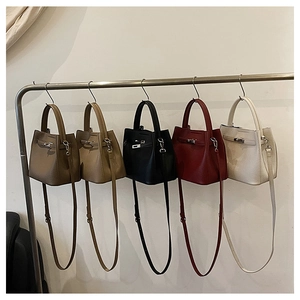 Detailed row of mini leather bucket bags in five colors with silver metallic hardware