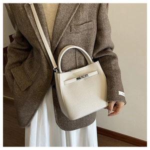 White litchi pattern leather bag detail featuring silver metal twist lock and buckle