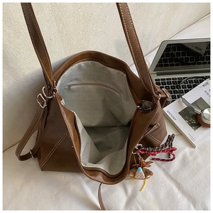 Top view of deep brown tote bag showing spacious herringbone lining and inner pocket