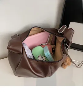 Internal view of large brown shoulder bag showing spacious storage for daily essentials