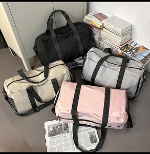 Macro detail of large travel bags in four colors with mesh side pocket and durable fabric