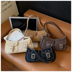 Detail of vintage retro shoulder bags in four colors with contrast stitching on a sofa