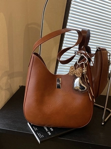 Vintage caramel brown hobo shoulder bag with leopard bow and silver heart charm decoration