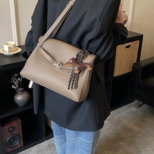 Litchi pattern leather tote bag with a silver twist lock and cute dachshund pendant charm
