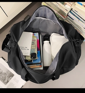 Internal view of a black nylon travel bag showing spacious compartments and mesh pockets