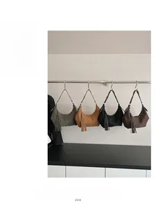 Detail view of four hobo bags with leather tassels and braided shoulder strap accents