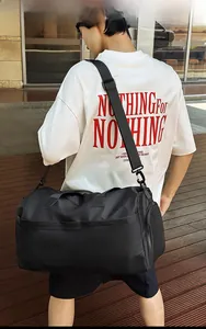 Outdoor shot of a black travel bag with dry-wet separation worn by a female model