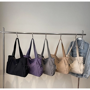 Variety of colors for the large capacity canvas tote bags shown on hangers