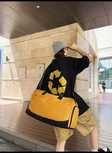 Outdoor city shot of yellow and black sports duffel bag with shoe compartment