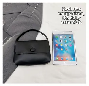 Size comparison of black leather handbag fitting daily essentials like a tablet