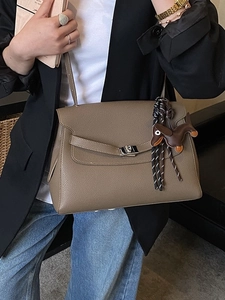Classic taupe pebble leather handbag with silver twist lock and dachshund charm detail