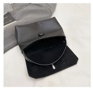 Detail view of the spacious black minimalist handbag with premium textured inner lining