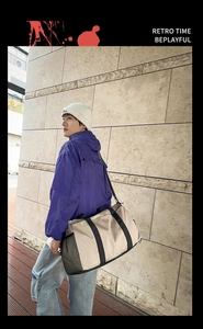 Detail of travel bag with side mesh pocket and adjustable strap shown on model outdoors