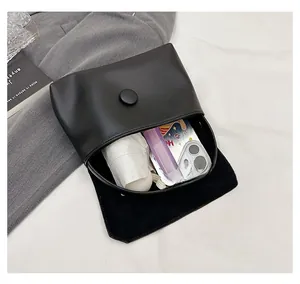Interior view of black flap crossbody bag showing storage capacity for daily essentials
