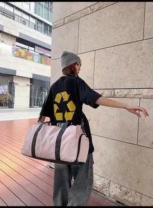 Pink gym bag featuring a large capacity main compartment and side wet/dry storage pocket
