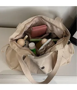 Detail view of large nylon tote bag showing spacious compartments and drawstring closure