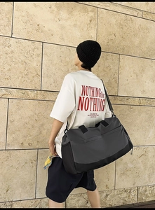 Detail of a large capacity fitness bag with side mesh pocket and detachable shoulder strap