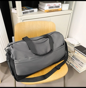 Waterproof nylon travel bag with shoulder strap and side mesh pocket shown on chair