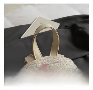 Detail of cream tweed fabric with pink texture and golden zipper on a stylish backpack