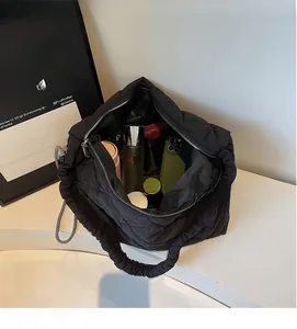 Macro view of large capacity black quilted tote bag showing spacious interior storage