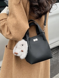 Chic black litchi pattern bucket bag with plush rabbit charm and crossbody strap