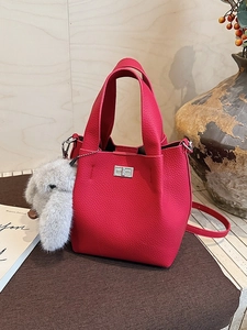 Pink lychee grain leather bucket bag with silver lock and plush rabbit charm