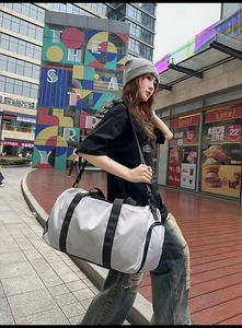 Detail of grey travel bag with waterproof fabric and side dry-wet separation zipper