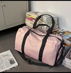 Pink travel bag detail showing side zipper compartment for shoes and wet-dry separation