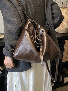 Dark brown high-gloss PU underarm bag with white stitching and silver hardware accents