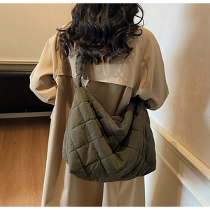 Close-up of olive green quilted tote bag showing high-quality diamond stitching texture