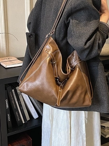 Brown soft leather tote bag with white contrast stitching for stylish commuting