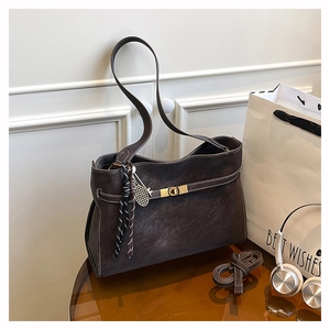 Detail of matte leather tote bag with white contrast stitching and gold twist lock
