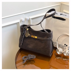 Detail view of large dark brown tote bag with metal buckle and detachable strap