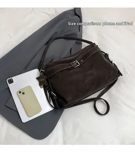 Dark brown motorcycle tote bag size comparison with smartphone and tablet devices
