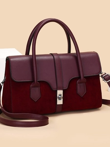 Burgundy textured leather handbag with suede patchwork and silver twist lock closure