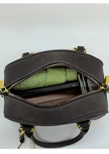 Top view of spacious brown Boston bag interior showing capacity for daily essentials